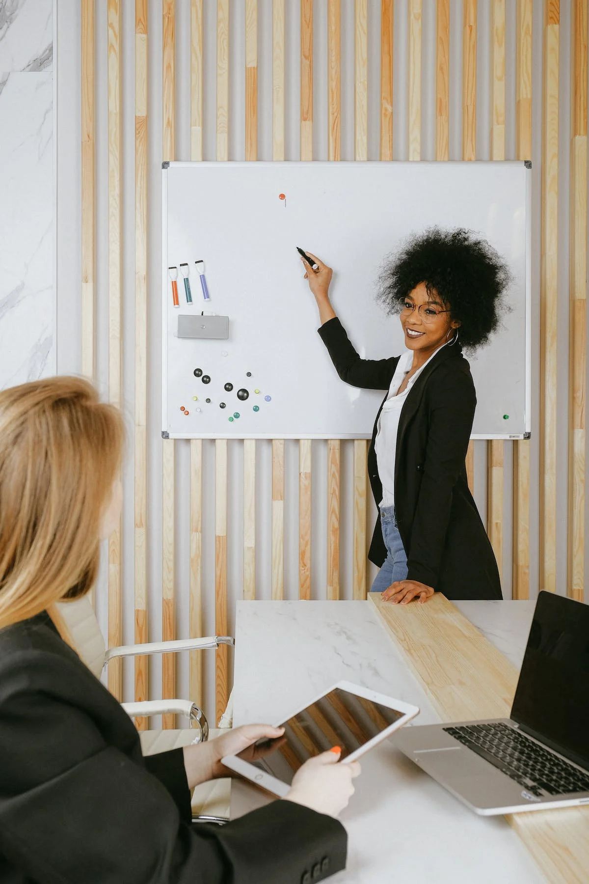 Woman using whiteboard in conference room